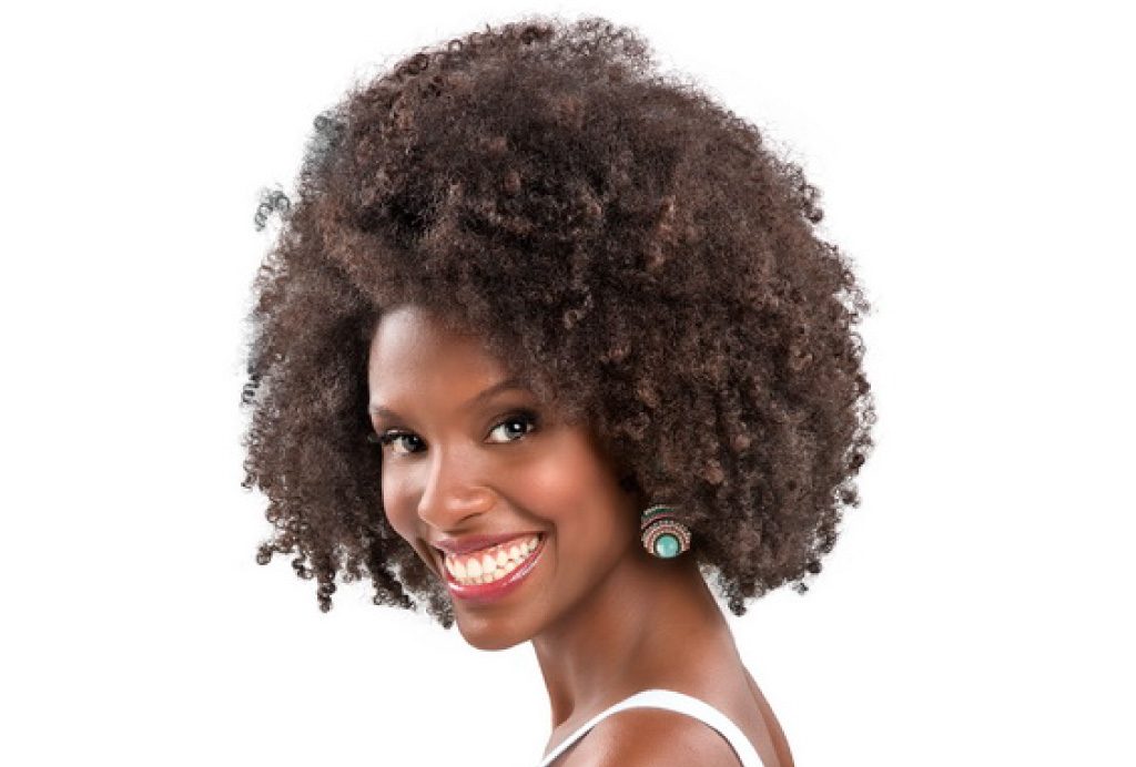 Modelo com cabelo black power médio de lado. 